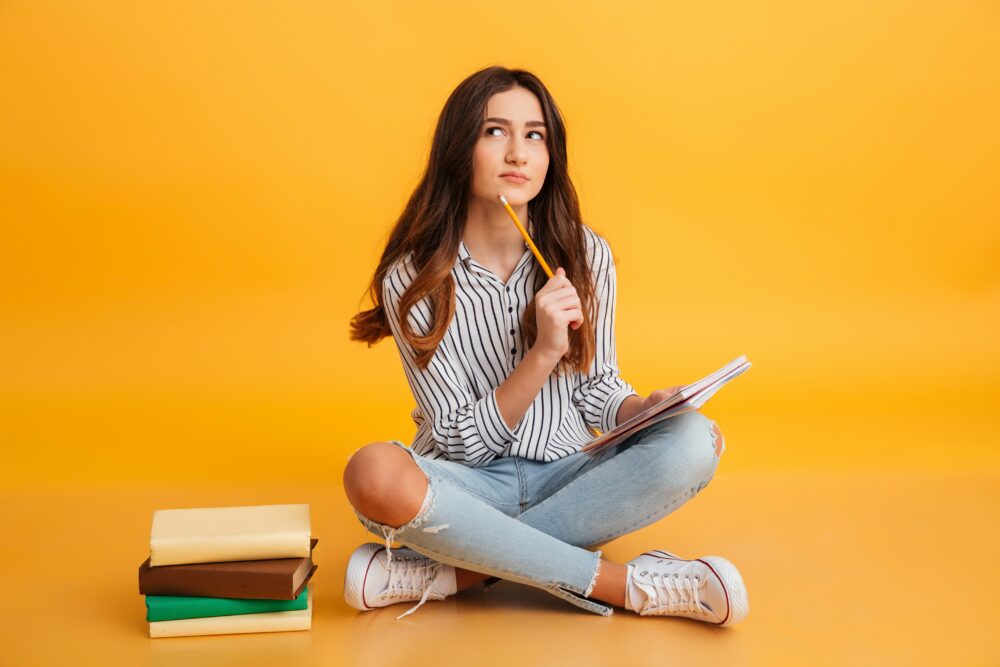 portrait-pensive-young-girl-making-notes