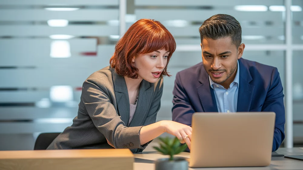 Two people discussing feedback: a way to increase engagement in your company.